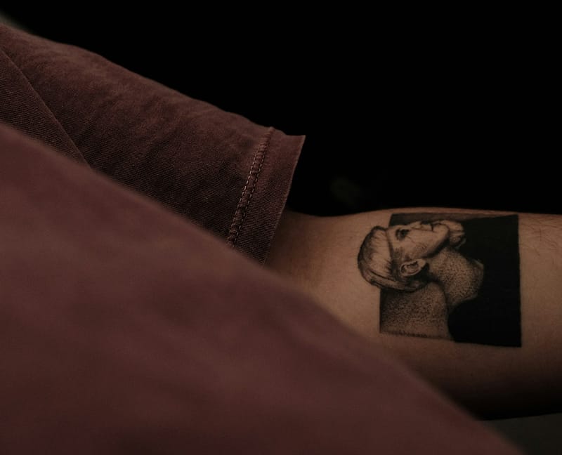 Détail d’un tatouage noir sur un bras